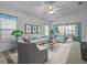 Bright living room featuring modern furniture and a ceiling fan at 21122 Lionheart Dr, Leesburg, FL 34748