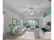 Bright living room featuring modern furniture and a ceiling fan at 21122 Lionheart Dr, Leesburg, FL 34748