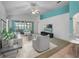 Bright living room featuring modern furniture and a ceiling fan at 21122 Lionheart Dr, Leesburg, FL 34748