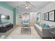 Bright living room featuring modern furniture and a ceiling fan at 21122 Lionheart Dr, Leesburg, FL 34748