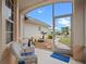 Relaxing screened porch with wicker chairs at 21122 Lionheart Dr, Leesburg, FL 34748