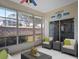 Bright sunroom with ample windows, wicker furniture, and serene views of the landscaped backyard at 21122 Lionheart Dr, Leesburg, FL 34748