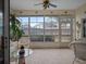 Relaxing sunroom with wicker furniture and view of backyard at 21122 Lionheart Dr, Leesburg, FL 34748