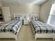 Two twin beds with matching bedding in a well-lit room at 2185 Victoria Dr, Davenport, FL 33837