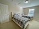 Two twin beds with plaid bedding share this bedroom at 2185 Victoria Dr, Davenport, FL 33837