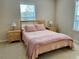 Bedroom with king-size bed and wooden nightstands at 2185 Victoria Dr, Davenport, FL 33837