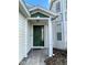 House exterior featuring a green front door and white columns at 2185 Victoria Dr, Davenport, FL 33837