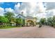 Gated entrance to community with brick pavers and lush landscaping at 2185 Victoria Dr, Davenport, FL 33837