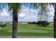 Serene view of a green golf course with homes in the background at 2185 Victoria Dr, Davenport, FL 33837