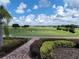 Landscaped walkway overlooking the driving range at 2185 Victoria Dr, Davenport, FL 33837