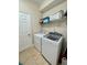 Laundry room with washer, dryer, and storage shelves at 2185 Victoria Dr, Davenport, FL 33837