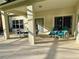 Covered patio with table, chairs, and lounge chairs at 2185 Victoria Dr, Davenport, FL 33837