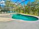 Sparkling pool with screened enclosure and lounge chairs at 2185 Victoria Dr, Davenport, FL 33837