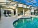 Inviting pool with screened-in enclosure and patio at 2185 Victoria Dr, Davenport, FL 33837