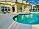 Relaxing kidney-shaped pool with screened enclosure at 2185 Victoria Dr, Davenport, FL 33837