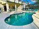 Inviting kidney-shaped pool with a covered patio at 2185 Victoria Dr, Davenport, FL 33837