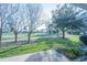 Gorgeous view of the golf course from the backyard, featuring mature trees, and a seating area at 2202 Margarita Dr, The Villages, FL 32159