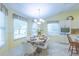 Well-lit dining nook with a chandelier, perfect for Gathering meals and entertaining at 2202 Margarita Dr, The Villages, FL 32159