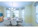 Charming dining area filled with light, featuring a table for six at 2202 Margarita Dr, The Villages, FL 32159