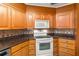 Bright kitchen with granite countertops and oak cabinets at 28228 Tammi Dr, Tavares, FL 32778