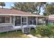 Screened porch with deck and steps leading to yard at 28228 Tammi Dr, Tavares, FL 32778