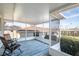 Relaxing screened porch with wicker chairs and rug at 28228 Tammi Dr, Tavares, FL 32778