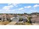 Aerial view of a house in a neighborhood with a golf course at 3257 Kilarny Pl, The Villages, FL 32163