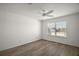 Well-lit bedroom with ceiling fan and wood-look floors at 3257 Kilarny Pl, The Villages, FL 32163