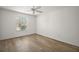 Spacious bedroom featuring light walls and wood flooring at 3257 Kilarny Pl, The Villages, FL 32163