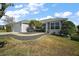 One-story home with gray siding, attached garage, and neatly landscaped yard at 3257 Kilarny Pl, The Villages, FL 32163