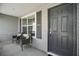 Front porch with two wicker chairs, providing a welcoming entrance at 3257 Kilarny Pl, The Villages, FL 32163