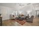 Light-filled living room with hardwood floors and comfy seating at 3257 Kilarny Pl, The Villages, FL 32163