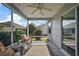 Relaxing screened porch with seating area and view of backyard at 3257 Kilarny Pl, The Villages, FL 32163