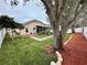 Large backyard with mature trees and brick pathway at 33304 Kaylee Way, Leesburg, FL 34788