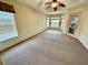 Spacious bedroom with carpet flooring, ceiling fan, and window seat at 33304 Kaylee Way, Leesburg, FL 34788