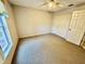 Well-lit bedroom with neutral carpeting and large closet at 33304 Kaylee Way, Leesburg, FL 34788