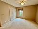 Charming bedroom with neutral carpeting and double-door closet at 33304 Kaylee Way, Leesburg, FL 34788