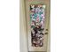 Door featuring beautiful stained-glass magnolia design at 33304 Kaylee Way, Leesburg, FL 34788