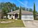 One-story house with a two-car garage and manicured lawn at 33304 Kaylee Way, Leesburg, FL 34788