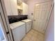 Bright laundry room with washer, dryer, and cabinets at 33304 Kaylee Way, Leesburg, FL 34788