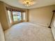 Carpeted room with a large bay window and ample natural light at 33304 Kaylee Way, Leesburg, FL 34788