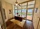 Sunroom with wood flooring, ceiling fan, and backyard access at 33304 Kaylee Way, Leesburg, FL 34788