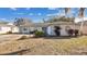 Single-story home with landscaped yard, driveway, and a light blue front door at 33352 Fountain Ln, Leesburg, FL 34788