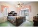 Bedroom with a ceiling fan, large window and sliding door to patio at 34245 Rosa Ln, Fruitland Park, FL 34731