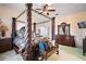 Main bedroom with a four-poster bed and ensuite bathroom at 34245 Rosa Ln, Fruitland Park, FL 34731