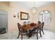 Elegant dining room showcasing a formal table, chandelier, and decorative mirror at 34245 Rosa Ln, Fruitland Park, FL 34731