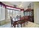 Bright dining room with large windows and a formal wood dining set at 34245 Rosa Ln, Fruitland Park, FL 34731