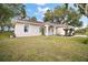 Single story house with mature trees and a large front yard at 34245 Rosa Ln, Fruitland Park, FL 34731