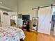 Bedroom with a barn door and hardwood floors at 3570 Rollingbrook St, Clermont, FL 34711