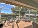 Relaxing screened porch with patio furniture and wood-like flooring at 3570 Rollingbrook St, Clermont, FL 34711